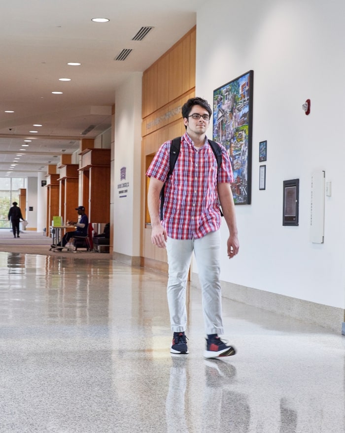 Student walking in Hatcher Center at MGA Macon campus